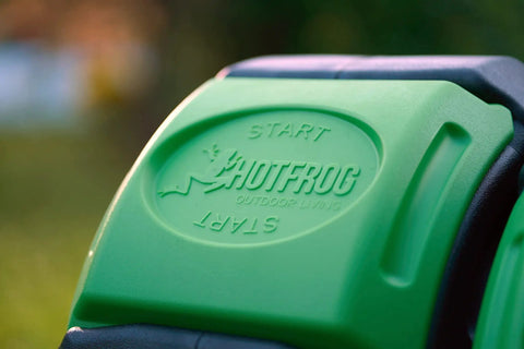 Close-up of the 37 Gallon Dual Chamber Tumbling Composter For Backyards with "START" embossed on green panel, showing outdoor use.