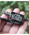 Hand holding DC 24V Linear Push-Pull Solenoid Electromagnet Open-Frame Spring Magnet Plunger With 10mm Stroke For Motor Starters