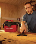 Man using Cordless Shop Vac Vacuum Cleaner Wet And Dry 2 Gallon Tank With 7 Foot Hose Bare Tool Only in home workshop