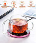 Electric Coffee Mug Warmer Heats Your Daily Brew Piping Hot With Precise Auto Timer And Dual Heat Settings Built From Scratch Safe Tempered Glass on a desk with a clear tea cup.