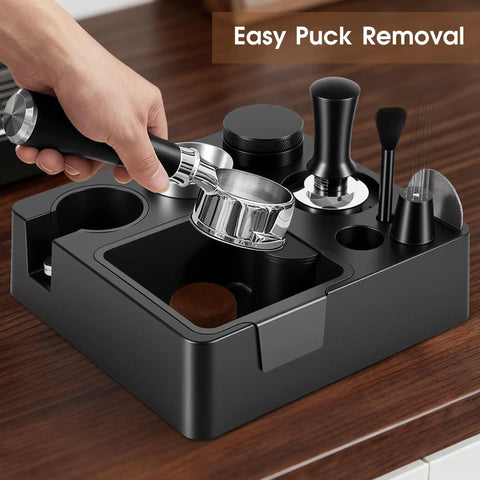 Kickass 58mm Espresso Accessories Kit With Integrated Tamping Station showcasing a hand holding the portafilter above the station.