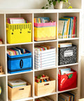 Six Pack Collapsible Fabric Storage Bins With Sturdy Handles For Classroom And Playroom on shelf, holding books and supplies.