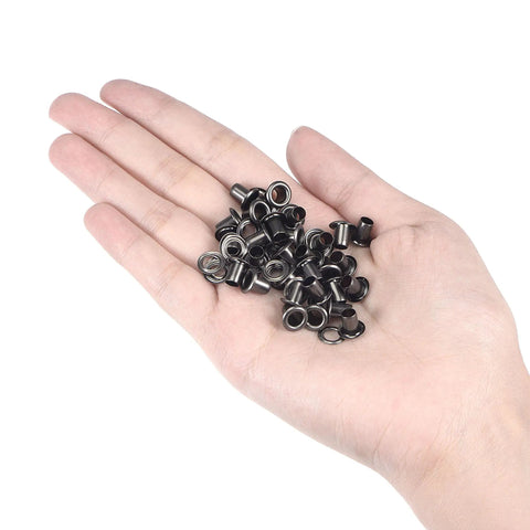 Hand holding Must-Have Copper Grommets Eyelets With Washers Kit 8x4x7mm Chrome Plated For DIY Craft Projects Black 200 Pieces