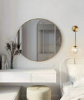 Mid Century Modern Wall Light With Adjustable Cord Raw Brass Round Glass Sconce And Amber Lampshade next to bed