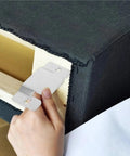 Close-up of heavy gauge snap lock connector being installed on sectional sofa for reinforcement.