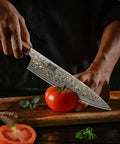 8 Inch Damascus Chef Knife 33 Layer Copper Pattern V Shaped Blade Ultra Sharp Kitchen Essential in action slicing a tomato.