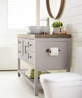 Bathroom scene with Matte Black Single Post Toilet Paper Holder Seven And A Quarter Inch Arrondi Bath Tissue Holder on gray vanity.