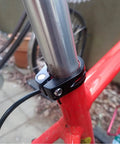 Lightweight Aluminum Quick Release Seat Post Clamp for 28.6mm bike frames in use on a red bicycle, 6061-T6 Alloy, black.