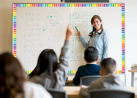 Teacher using Colorful Stripes Magnetic Border Set With 12 Magnetic Strips, 24 Feet Of Classroom Border Tape for whiteboard decor