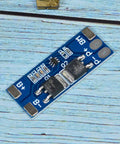 No Fuss 2 Pack 2S BMS For 18650 Lithium Cells 7 4V Balanced Charging Guard circuit board with connectors on a wooden table.