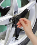 Hand installing Heavy Duty 21 Piece Steel Wheel Lug Nuts With Anti Theft Hex Design on a silver car wheel.