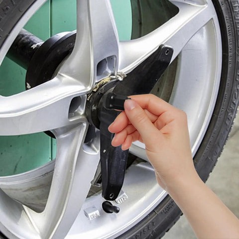 Hand installing Heavy Duty 21 Piece Steel Wheel Lug Nuts With Anti Theft Hex Design on a silver car wheel.