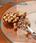 Round Lazy Susan Turntable With Smooth Aluminum Bearings And Heavy Duty Tempered Glass Swivel Serving Tray For House Parties Family Dinners And Holiday Feasts Easy Breezy Cleanup 34 Inch with nuts on a clean glass surface.