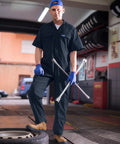 Men's Short Sleeve Coveralls For The Daily Grind, Lightweight Twill Mechanic Jumpsuit With Cargo Pockets, All-Day Breathable Shop Gear Built Tough To Crush Long Shifts While Keeping You Cool On The Floor, worn by a male mechanic.