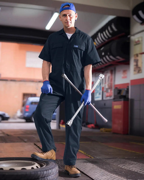Men's Short Sleeve Coveralls For The Daily Grind, Lightweight Twill Mechanic Jumpsuit With Cargo Pockets, All-Day Breathable Shop Gear Built Tough To Crush Long Shifts While Keeping You Cool On The Floor, worn by a male mechanic.