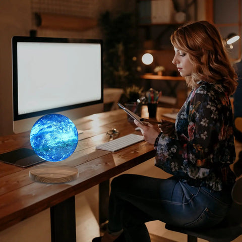 Levitating Galaxy Moon Lamp With 18 Color Modes Floating 3D Moon Light on desk near woman working on tablet