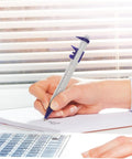 Person writing with caliper ballpoint pen from Science Party Stationery Gift Set With 12 Sticky Notes 12 Ballpoint Pens And 50 Science Stickers