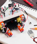 Ten Pack Of Tiny 130 Miniature DC Motors With Wire For DIY Toys And Science Projects And Small Electronics 1.5V To 6V Power Range Up To 16000 RPM At 3V Dope Micro Motors For Makers on a desk with electronics project.
