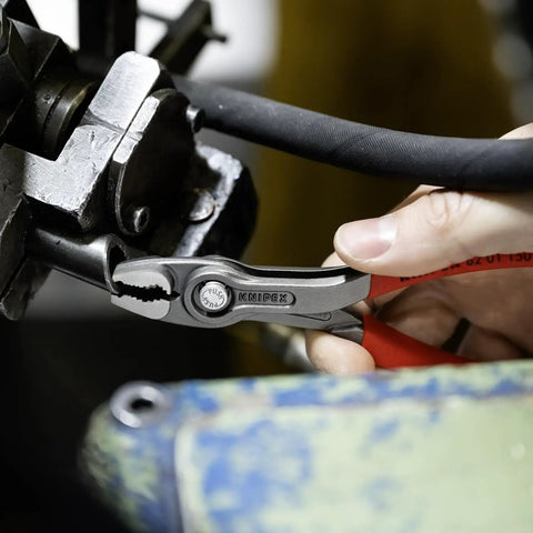 Using 6-inch pliers with front and side jaws to grip fasteners on machinery