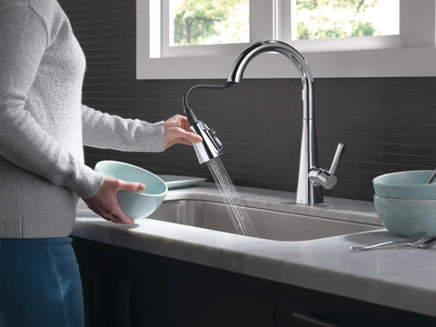 Person using Lenta Chrome Kitchen Faucet with Pull Down Sprayer, modern single hole sink tap, in kitchen setting
