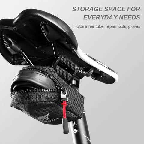 Compact Under Seat Cycling Saddle Bag attached to road bike, featuring easy access zipper and durable nylon shell for secure storage