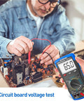 Man using Garage Ready Automotive Engine Analyzer Multimeter With NCV to test circuit board voltage.