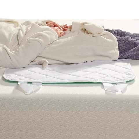 Waterproof Bed Pad And Mattress Protector For Furniture Or Seat Covers With Quilted Slide Sheet And Four-Layer Protection shown on bed