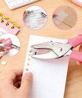 Two Piece Hole Punch Set Circle Punches One Quarter Inch And One Eighth Inch With Pink Soft Grip Handles used on paper