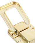 Close-up of a Retro Vintage Toggle Hasp Latch, antique yellow metal, ideal for wooden trunks and storage furniture.