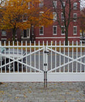White double gate with 18 Inch Drop Cane Bolt Gate Latch, beefy heavy duty black solid steel ground drop rod securing the gate.