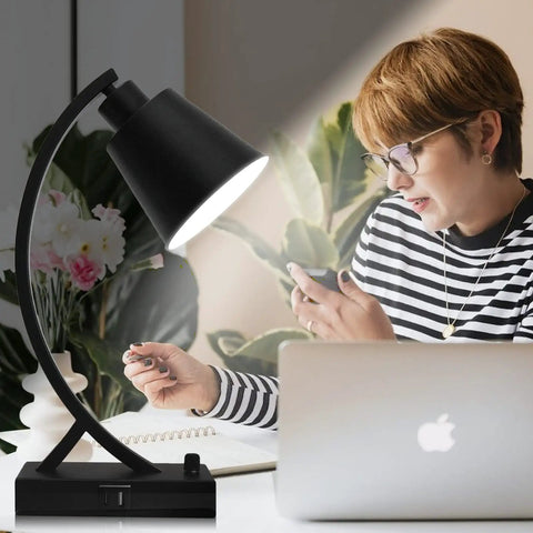 Dimmable Black Desk Lamp With USB A And USB C Ports Built In AC Outlet Rotary Dimmer Switch Bedside Nightstand Light For Bedroom Living Room Office Bulb Included Great For Home Office And Study next to a person using a laptop.