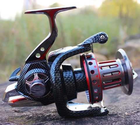 Surf Spinning Reel Size 10000 12000 For Saltwater Fishing with full metal frame and 31 lb max drag on a rock surface.
