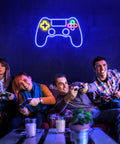 Neon Game Controller LED Sign For Gaming Room Decor glowing above gamers playing