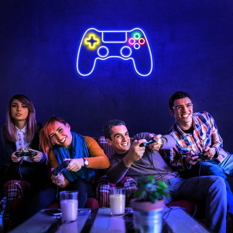 Neon Game Controller LED Sign For Gaming Room Decor glowing above gamers playing