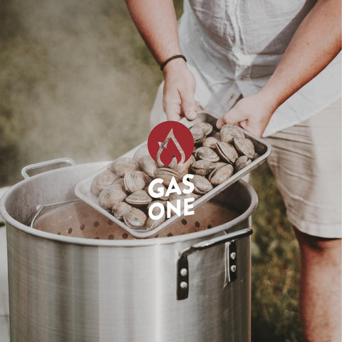 Seafood Boil Kit With Propane Burner And Regulator, 60 Quart Pot With Basket, showing clams being added to boiling pot outdoors