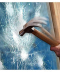 A hammer striking glass protected by 8 Mil Clear Window Film For Security And Safety 24 Inch 12 Foot Roll Interior Application Helps Resist Break Ins And Shattered Glass Meets ANSI Z97 1 Class B And CPSC Category 1 Standards.