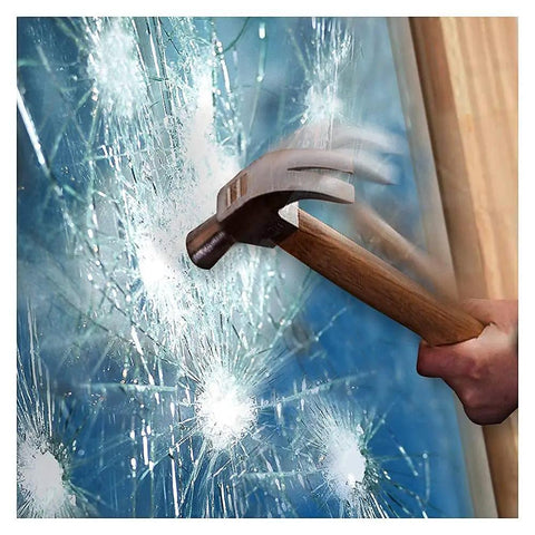 A hammer striking glass protected by 8 Mil Clear Window Film For Security And Safety 24 Inch 12 Foot Roll Interior Application Helps Resist Break Ins And Shattered Glass Meets ANSI Z97 1 Class B And CPSC Category 1 Standards.