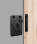 No Sweat Black Carbon Steel Sliding Barn Door Latch Lock With Slick Powder Coated Finish mounted on a grey wall.