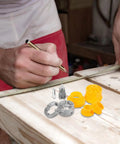 Person measuring wood with Heavy Duty Alloy Iron Pipe Threader Tool Kit With Multiple Dies For Hose And Water Pipes nearby.