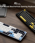 Wired Full Size Mechanical Gaming Keyboard with 104 Keys and Premium Metal Volume Knob Featuring Five Layer Sound Dampening on wooden desk.
