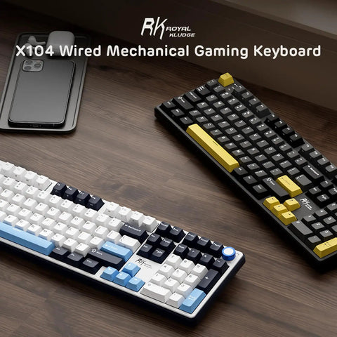Wired Full Size Mechanical Gaming Keyboard with 104 Keys and Premium Metal Volume Knob Featuring Five Layer Sound Dampening on wooden desk.