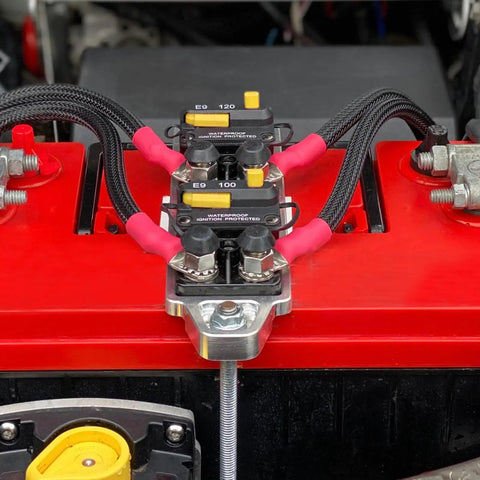 Badass 175A Circuit Breaker With Darn Tough IP67 Seal And Switchable Manual Reset For Car Truck Rv Marine Boat And Heavy Duty Battery Protection, installed near a red battery.