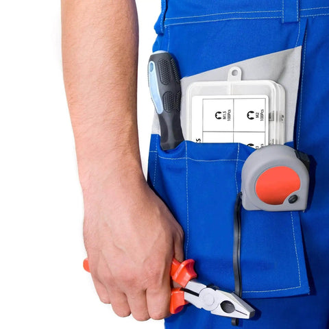 Person in blue overalls holding pliers, with a 580 Piece Black Alloy Steel E Clip Set With 10 Size Assortment M1.5 To M10 Kit in pocket.