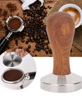 58mm Stainless Steel Coffee Tamper with Wooden Handle next to espresso and coffee beans