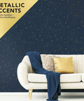 Living room with Upon A Star Navy And Metallic Peel And Stick Wallpaper, featuring a star pattern behind a beige sofa with cushions.