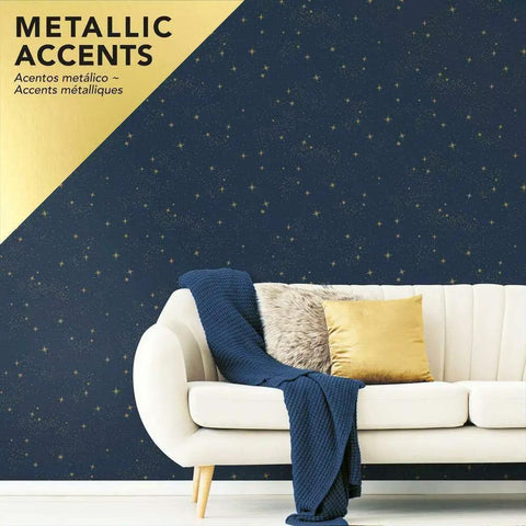 Living room with Upon A Star Navy And Metallic Peel And Stick Wallpaper, featuring a star pattern behind a beige sofa with cushions.
