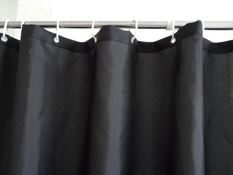Black Fabric Shower Curtain Liner Lightweight Washable Cloth For Bathroom With Bottom Weight And Water Repellent Finish No Fuss Easy Care No PVC 72 By 72 Inches hanging on rod up close.