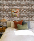 Bedroom with vintage brown brick peel and stick wallpaper, faux 3D brick for walls, eco-friendly adhesive beside bed and painting.