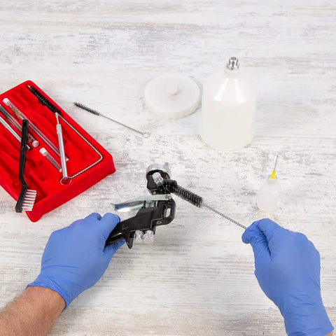 All-In-One Pro-Grade Spray Gun Cleaning Kit With 23-Piece Maintenance Set For HVLP Gravity Suction Detail And Paint Guns, Air Tools And Airbrush, Comprehensive Cleaning Accessories And Sturdy Storage Case Included. Hands cleaning spray gun with brush and kit case