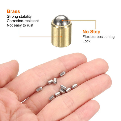 30 Pack Of Snappy Mini Brass Ball Spring Plungers 6X7mm Heavy Duty Detent Catch Latches For Cabinet Doors And Garage Builds Smooth Operator Action And Rock Solid Workhorse Quality. Hand holding brass ball and mini plungers.
